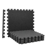 Zwarte puzzelmat set tegels, met in elkaar grijpende randen en stapelbare delen.